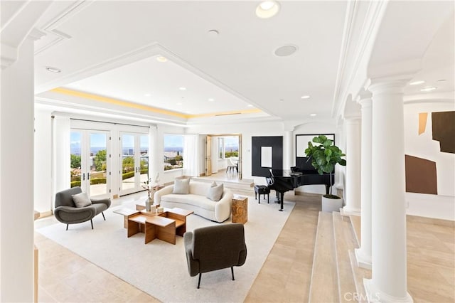 living room with ornate columns, french doors, crown molding, and a tray ceiling