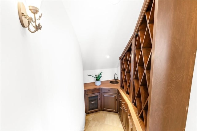 wine room with vaulted ceiling and sink