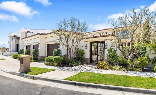 mediterranean / spanish house featuring a garage