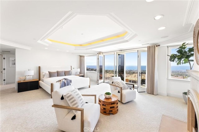 carpeted bedroom with access to exterior, ornamental molding, a water view, and a tray ceiling