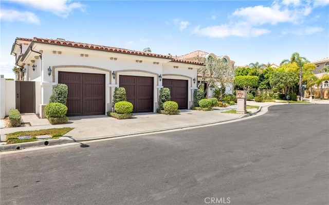 mediterranean / spanish home featuring a garage