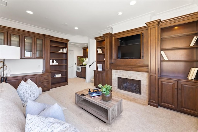 carpeted living room with a fireplace and ornamental molding