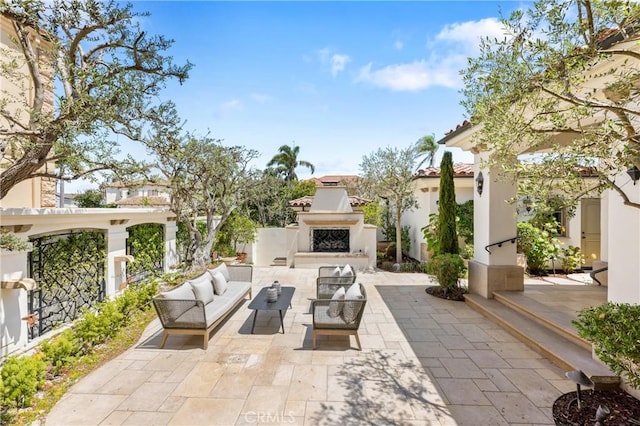 view of patio / terrace with an outdoor living space with a fireplace