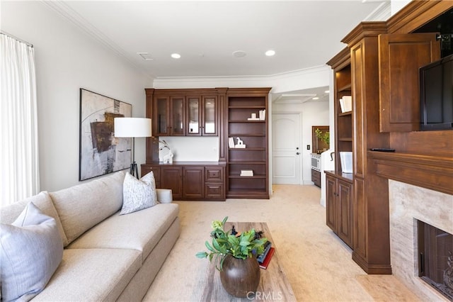 carpeted living room featuring a fireplace and crown molding