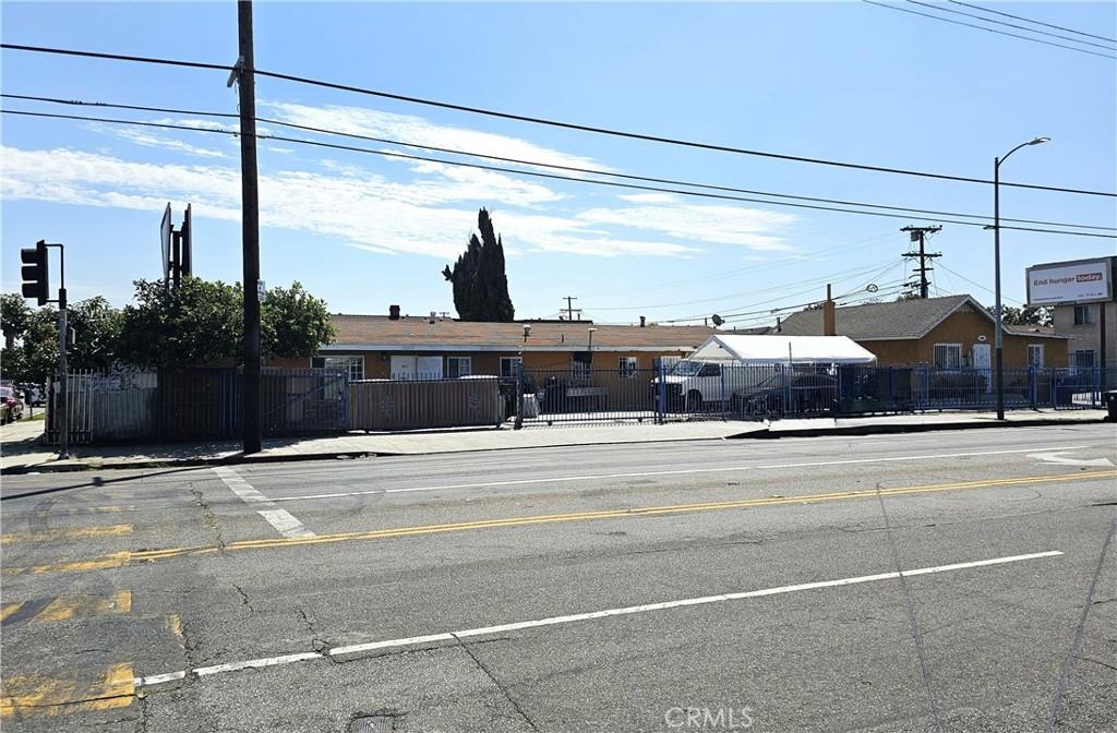 view of street featuring sidewalks, street lighting, and curbs