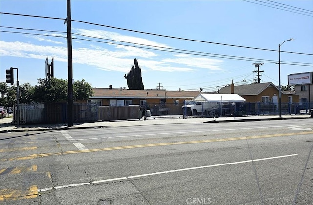 view of street featuring sidewalks, street lighting, and curbs