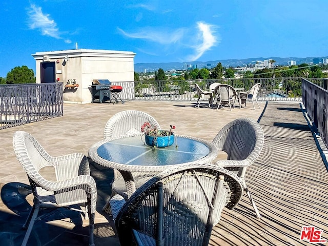 view of patio with area for grilling and a mountain view