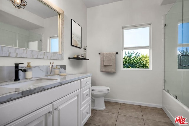 full bathroom with tile patterned floors, vanity, toilet, and combined bath / shower with glass door