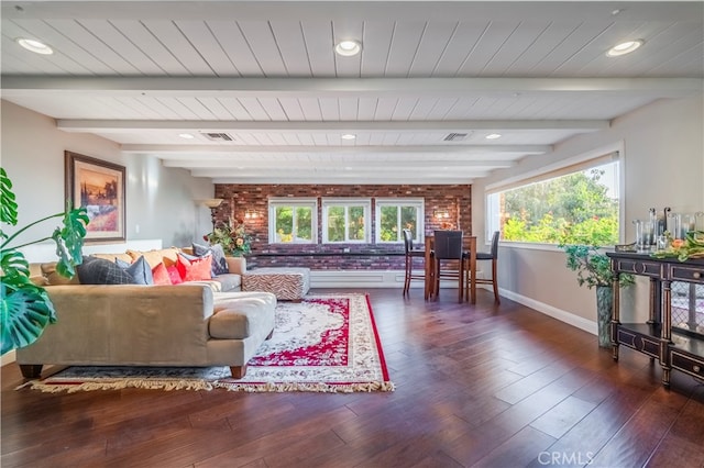 living room featuring beamed ceiling and dark hardwood / wood-style floors