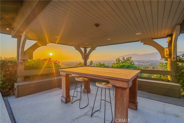 patio terrace at dusk with a mountain view