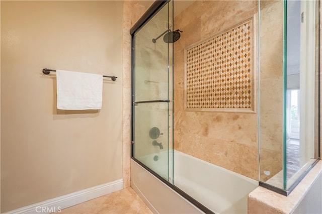 bathroom featuring tile patterned flooring and combined bath / shower with glass door