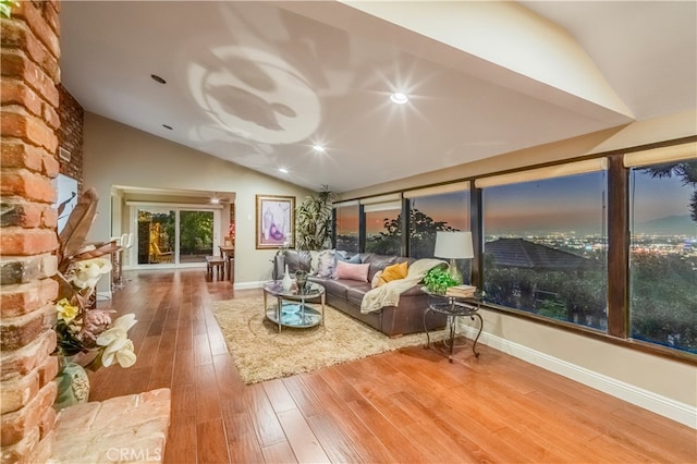 living room featuring hardwood / wood-style flooring and lofted ceiling