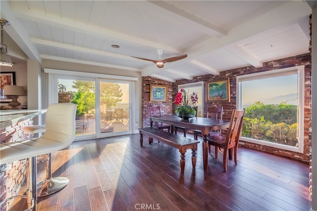 dining space with lofted ceiling with beams, ceiling fan, brick wall, and dark hardwood / wood-style flooring