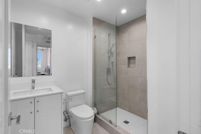 bathroom featuring tile patterned floors, vanity, toilet, and an enclosed shower