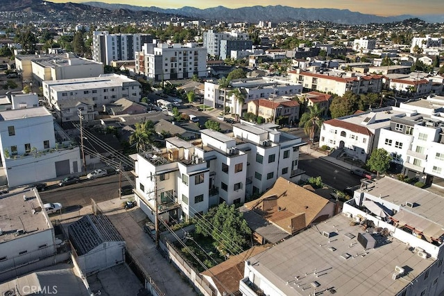 aerial view at dusk featuring a mountain view