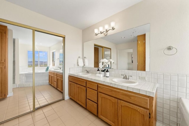 bathroom featuring tile patterned flooring, a bathing tub, and vanity