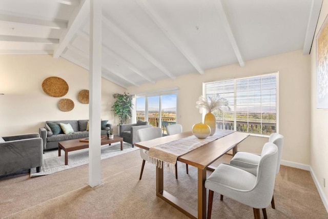 dining area with lofted ceiling with beams and carpet floors