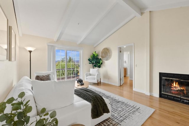 living room featuring vaulted ceiling with beams and hardwood / wood-style floors