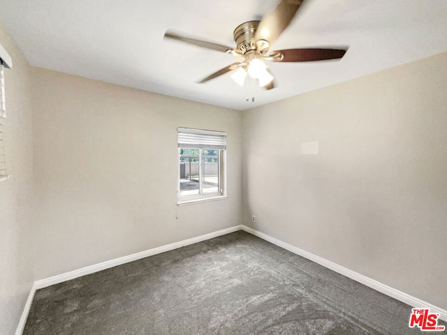 unfurnished room with dark carpet and ceiling fan