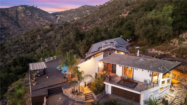 aerial view at dusk featuring a mountain view