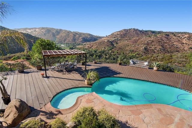 view of pool with a deck with mountain view