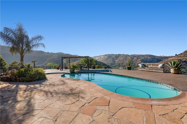 view of pool with a mountain view, a patio, and a pergola