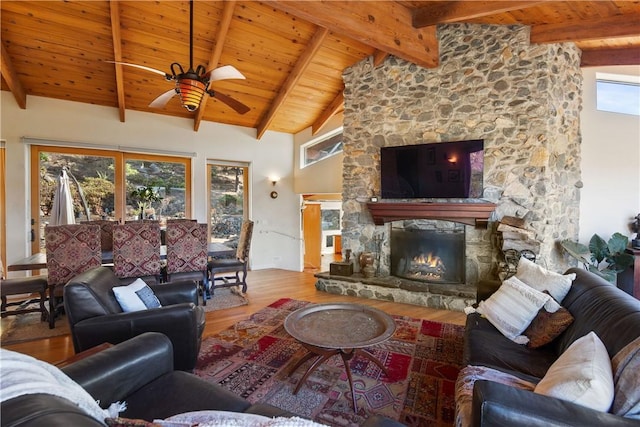 living room with a fireplace, wood-type flooring, high vaulted ceiling, and beamed ceiling