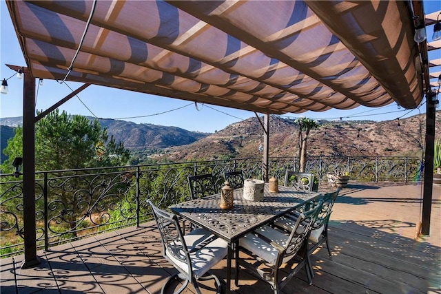 wooden terrace featuring a pergola and a mountain view