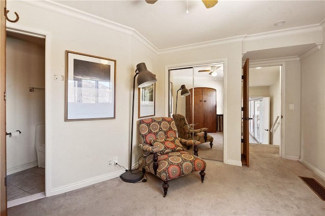 sitting room featuring light carpet and crown molding