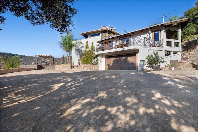 view of front of house featuring a balcony and a garage