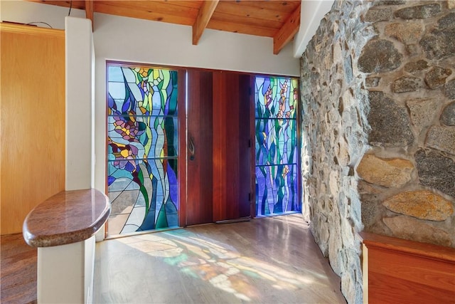 entryway featuring beam ceiling, wood-type flooring, and wood ceiling