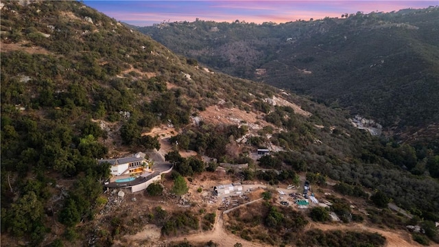 aerial view at dusk featuring a mountain view