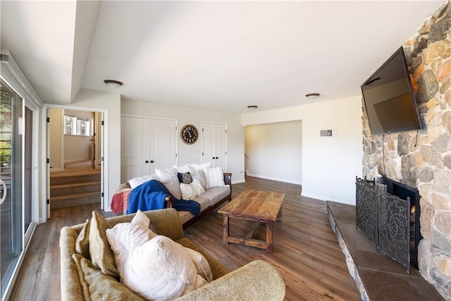 living room with dark hardwood / wood-style floors and a fireplace