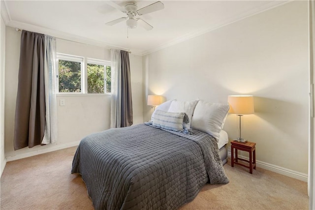 carpeted bedroom with ceiling fan and crown molding