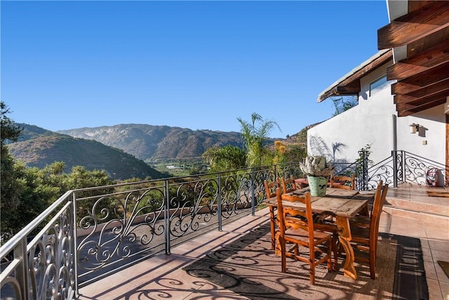 exterior space featuring a mountain view and a balcony