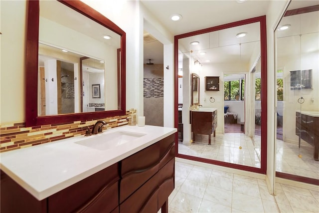 bathroom with vanity, tasteful backsplash, and tile patterned floors