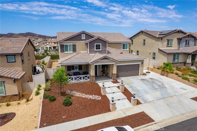 34334 Swordfern Pl, Murrieta, CA 92563 - view of front of home with a mountain view, solar panels, and a garage