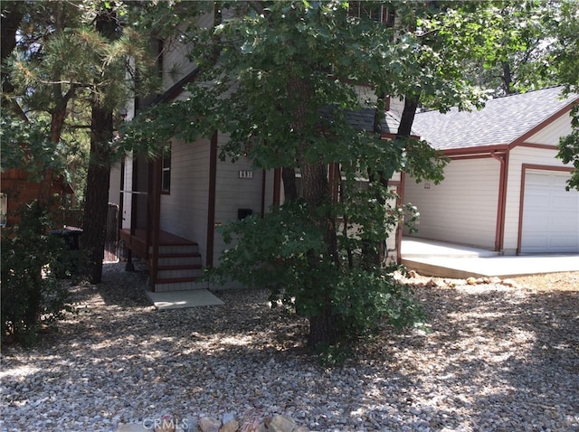 obstructed view of property with a garage