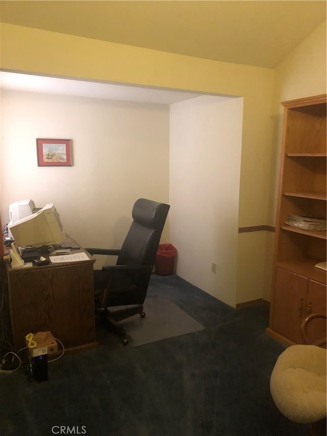 office featuring dark carpet and lofted ceiling