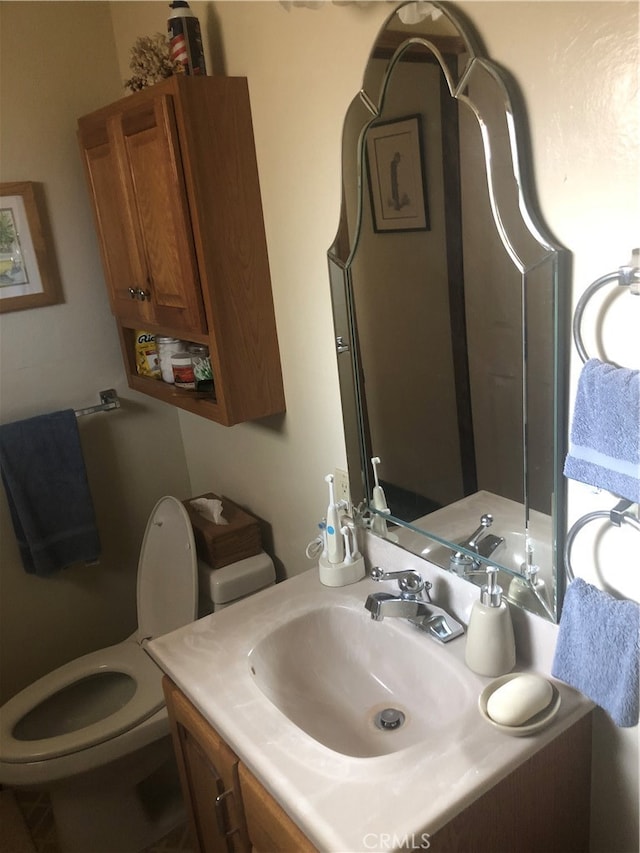 bathroom featuring vanity and toilet