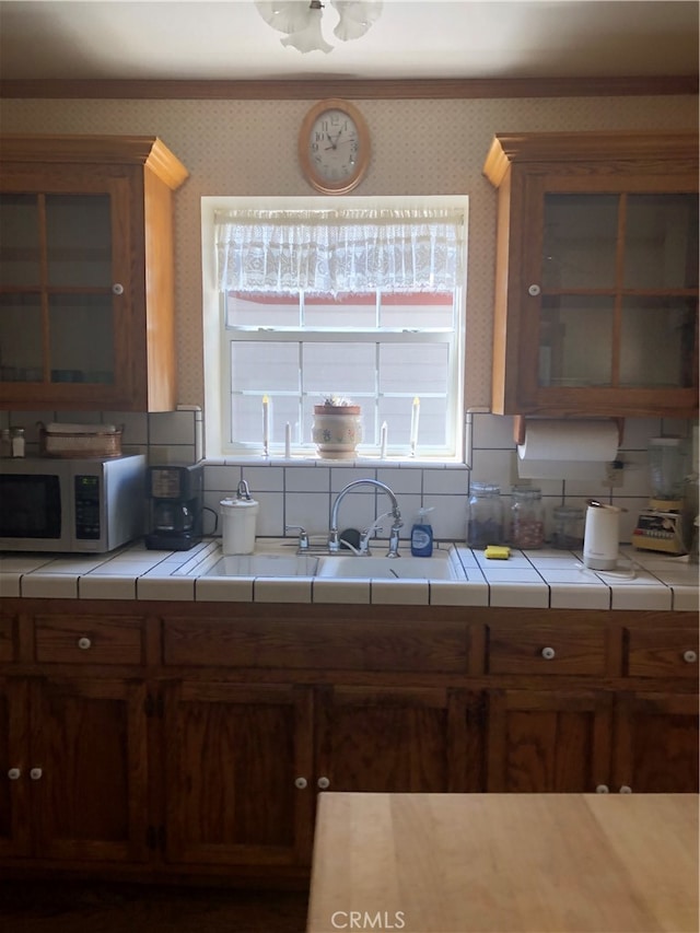 kitchen with backsplash, sink, and tile countertops