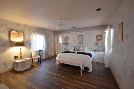 bedroom with dark hardwood / wood-style floors and ceiling fan