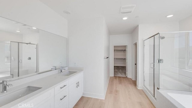 bathroom featuring vanity, wood-type flooring, and independent shower and bath