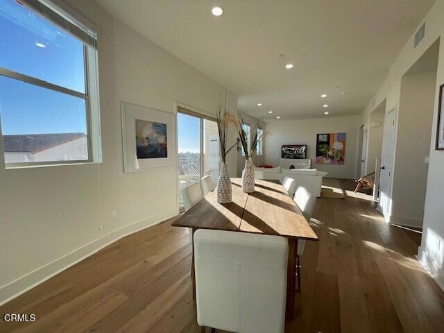 interior space with visible vents, baseboards, dark wood-type flooring, and recessed lighting