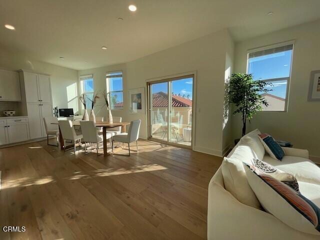 dining space with light wood-type flooring and recessed lighting