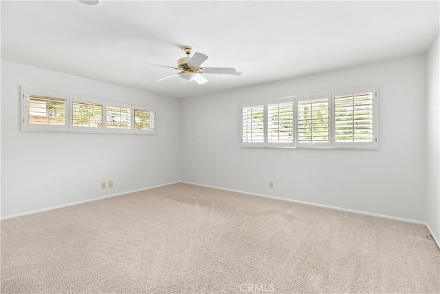 unfurnished room featuring ceiling fan and carpet flooring