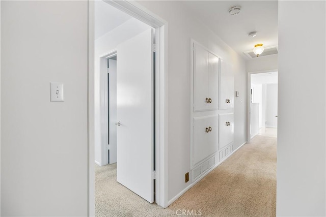 corridor featuring light colored carpet