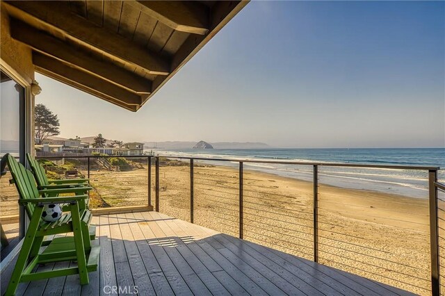 deck featuring a water view and a beach view