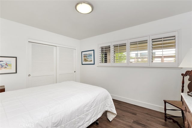 bedroom featuring a closet and dark hardwood / wood-style floors