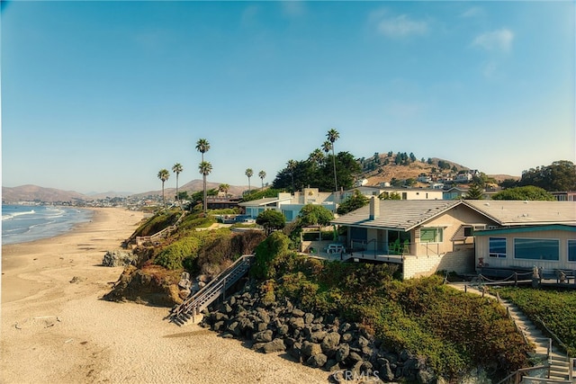 exterior space with a beach view and a water view